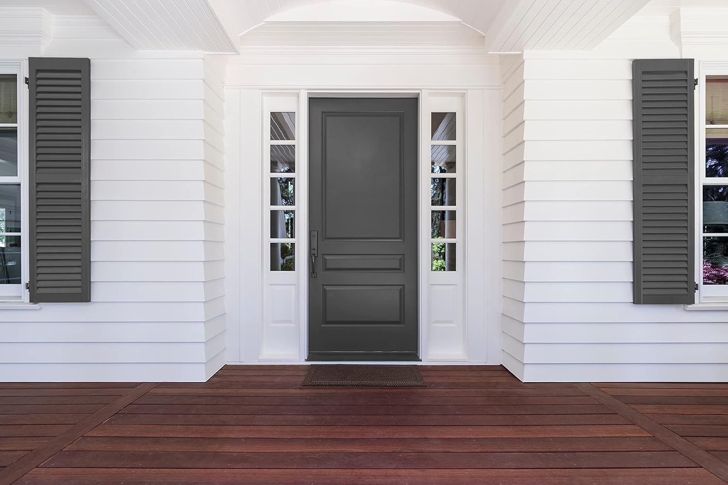 A front entrance with a dark gray door in satin finish paint, sidelights with glass panes, white siding, gray shutters, and a wooden porch floor.
