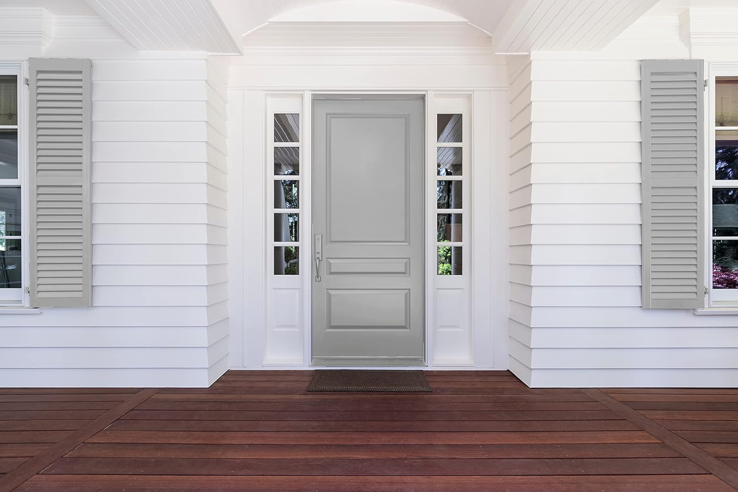 A front porch with a dark wooden floor, white paneled walls, two light gray shutters, and a light gray door flanked by narrow side windows—all refreshed using hPremium interior paint for a smooth, lasting finish.