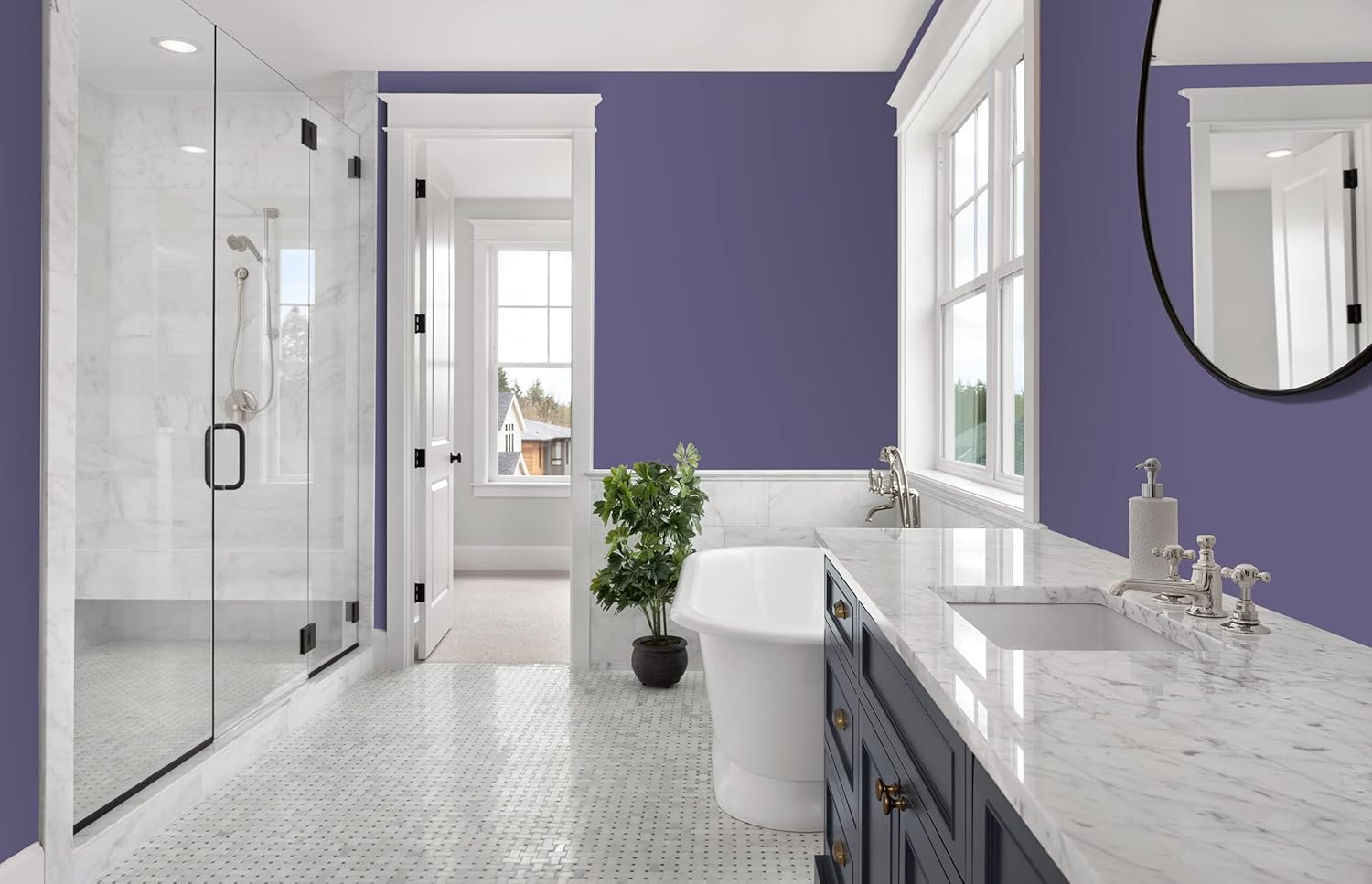 Modern bathroom with bold purple walls in premium paint, white marble countertop and floor, glass shower, freestanding tub, large mirror, and a potted plant by the window letting in natural light.