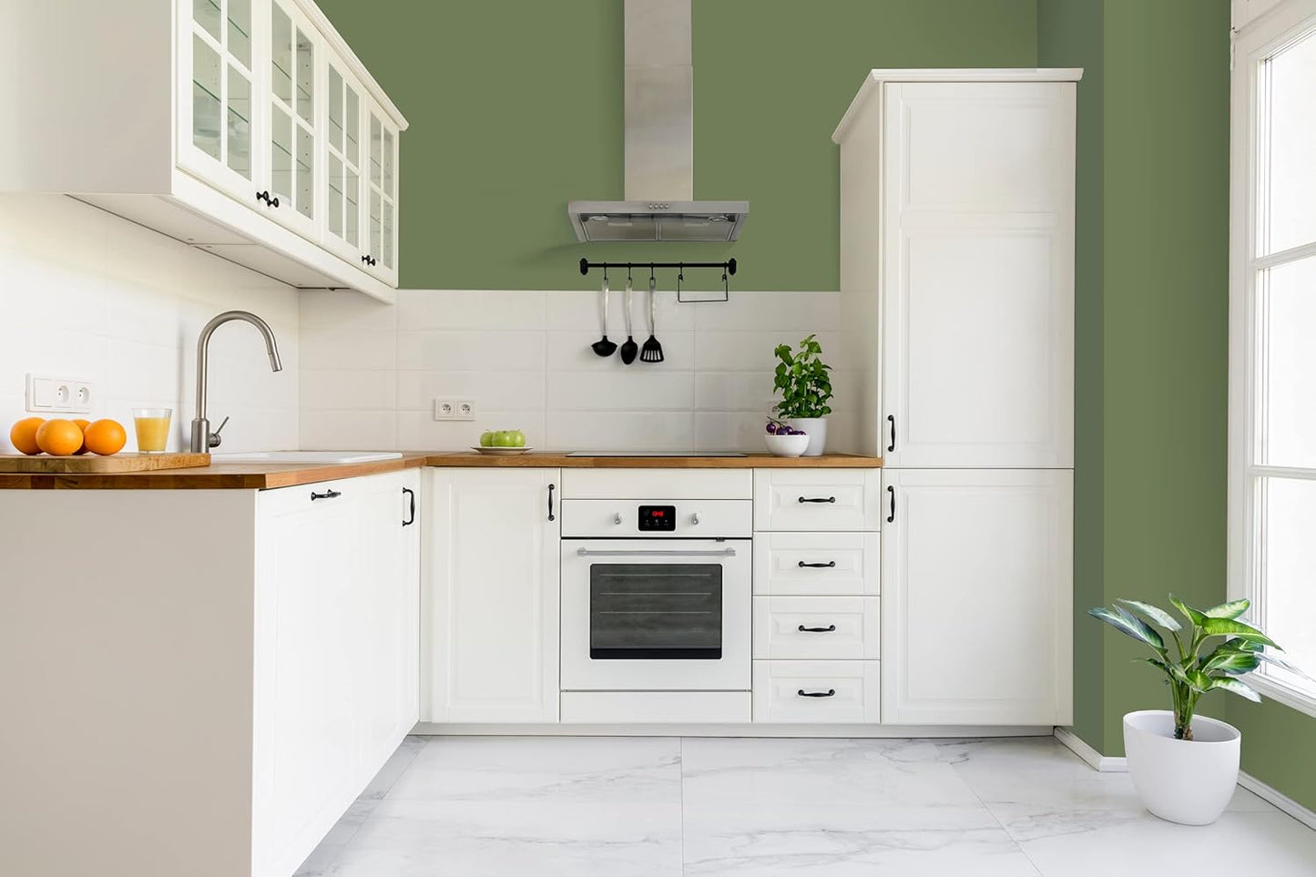 A modern entryway featuring wooden stairs with elegant black railings, leading up to a spacious dining area. The walls are painted a soft green and the floor is polished hardwood, illuminated by natural light from the dining room.